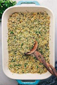 a casserole dish filled with rice and herbs