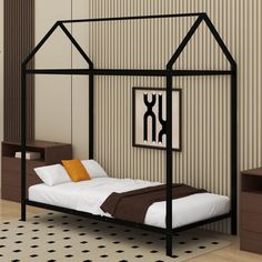 a black metal bed frame with white sheets and brown pillows in a small bedroom area