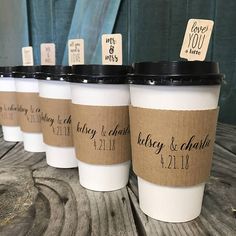 six coffee cups with labels on them are lined up