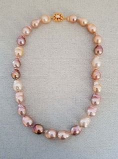 "This is a gorgeous pink white purple baroque pearl necklace made with 100 % natural cultured pearl and 18 kt yellow gold plated on sterling silver. Necklace Length: 17 \" Baroque Pearl: 15x15 to 12x12mm Italian made 925 Sterling Silver Clasp: 18mm The necklace is a beautiful statement piece with personality and really stands out. It is absolutely stunning and attractive. And it is easy to wear in any occasion. Pearl is the birthstone of june. Overtime, pearl has become the symbol of purity.   Please feel free to message me if you want to see more photos or make any modifications on the necklace. International Buyers Please Pay Attention: Import duties, taxes, and charges are not included in the item price or shipping cost. These charges are the buyer's responsibility. Please check with yo Pink Baroque Pearl Single Strand Necklace, Pink Single Strand Baroque Pearl Necklace, Pink Single Strand Baroque Pearl Jewelry, Pink Single Strand Pearl Necklace For Gift, Pink Pearl Necklace With High Luster, Pink Pearl Necklace With Round Beads For Gift, Pink Pearl Necklace For Gift, Pink Round Beads Pearl Necklace For Gift, Pear-shaped Pearl Necklace With High Luster