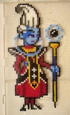 a beaded picture of a cartoon character with a hat and holding a wand in his hand