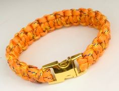 Introducing our vibrant Yellow Orange Paracord Bracelet with a unique twist - Blue and Yellow speckles! This one-of-a-kind bracelet is handcrafted with a classic cobra stitch, making it the perfect accessory to add some color and style to any outfit. Made with a single piece of strong and durable 8 feet, 7 strand 550 Paracord, this bracelet is not only fashionable, but also practical in case of any emergency situations. The Gold Tone Side Release Buckle adds a touch of elegance and functionality Pink Olive, Classic Bracelets, Paracord Bracelet, 550 Paracord, Paracord Bracelets, Unique Bracelets, Minimalist Wallet, Crochet Slippers, Braided Bracelets