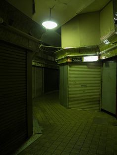 an empty storage room with closed doors at night