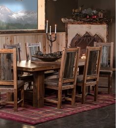 a dining room table and chairs in front of a painting