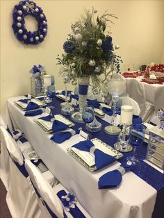 the table is set with blue and white decorations