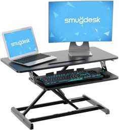 a laptop computer sitting on top of a desk next to a keyboard and mouse pad