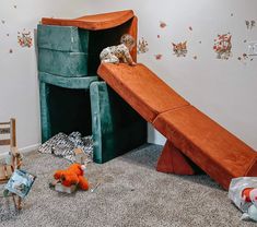 a child's room with stuffed animals on the floor, and a slide in the corner