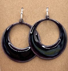 Dark Purple Enameled Copper Hoop Earrings  These earrings are kiln fired enamel on copper.  Includes sterling silver plated ear wires. Earring itself measures 1 3/8 inches in length; the width is approximately 1 1/4 inches at the widest point; 1 3/4 inches in length from ear wire. Handmade in my garage studio in Glen Allen, VA. Enameling is a process in which powdered glass is fused to a metal at high heat (generally between 1,400 and 1,650 degrees Fahrenheit). This piece started with a shape cut out of copper, referred to as a blank.  I source my blanks from various other Etsy shops and local stores in Richmond, VA.  The copper is cleaned and then a layer of counter enamel is applied to the back of the piece and fired in the kiln.  The counter enamel helps to keep the piece from warping a Garage Studio, Grunge Jewelry, Enameled Copper, Funky Jewelry, Richmond Va, Enamel Earrings, Fine Jewels, Pretty Jewellery, Ear Wire