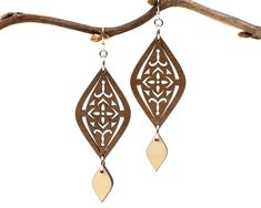 "A Moroccan tile-inspired design gives these earrings a worldly vibe, and a dangling charm adds elegance. Two tones of intricately cut wood - walnut and maple - give additional texture to the piece. Laser cut wood earrings can be dressed up or down, making them the perfect complement to any outfit! These earrings are strong but so lightweight and comfortable, you will hardly know you have them on! Pair with the matching Moroccan necklace for a coordinated look: https://www.etsy.com/listing/81235 Elegant Brown Plug Earrings As Gift, Elegant Brown Plug Earrings For Gift, Laser Earrings, Moroccan Necklace, Laser Cut Wood Earrings, Laser Cut Earrings, Cut Earrings, Silver Earrings Handmade, Moroccan Tile