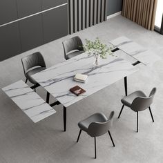 a marble table with chairs around it and a book on the table next to it