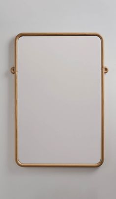 a square mirror mounted on the wall