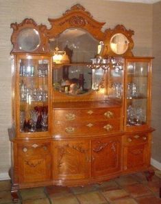 an old fashioned china cabinet with glass doors