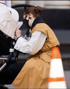 a woman sitting next to a baby in a stroller