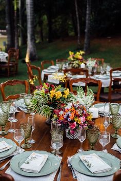 the table is set with flowers and place settings