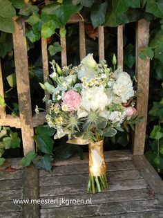 a bouquet of flowers sitting on top of a wooden chair