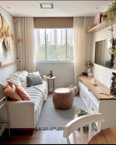 a living room filled with furniture next to a window