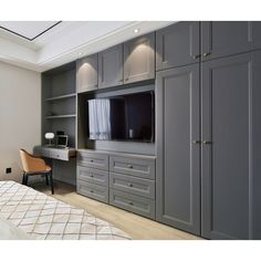 a bedroom with gray cabinets and a television