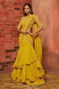 A blouse with full sleeves is a new trend and is a great way to cover your arms most stylishly. Highlight your basic blouse designs with the trendy full sleeves that are sure to be a head-turner.  ... less Yellow Ruffle Saree, Yellow Haldi Outfit, Yellow Sari, Haldi Ceremony Outfit, Haldi Dress, Haldi Outfits, Net Blouse, Haldi Outfit, Ruffle Saree