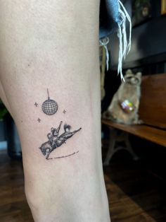 a woman's leg with a tattoo on it that has a skier skiing in the air