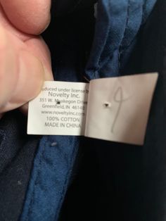 someone is holding onto the label on their jacket