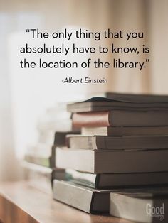 a stack of books sitting on top of a wooden table next to a quote from albert einstein