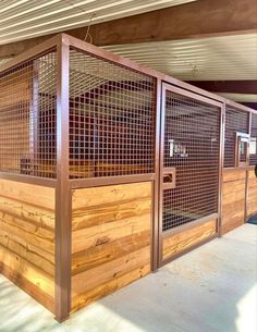 a wooden fence with metal bars on the top and bottom part, in front of a building