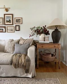 a living room filled with lots of furniture and pictures on the wall above it's coffee table