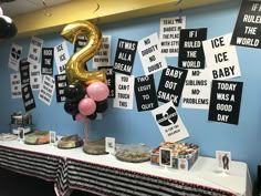 a table with balloons and signs on it