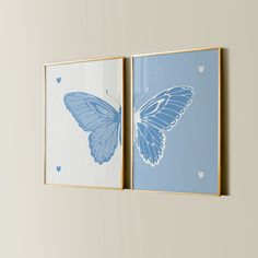 two blue butterfly paintings hanging on the wall