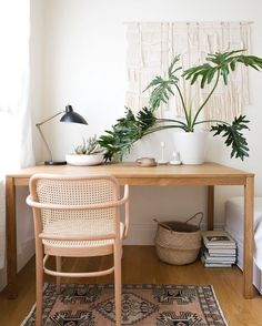 a wooden desk topped with potted plants on top of it next to a window