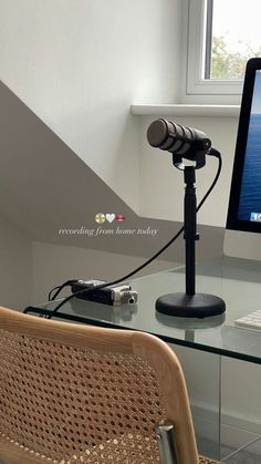 a computer monitor sitting on top of a glass desk