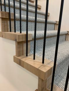 a set of stairs with metal railings and wood handrails