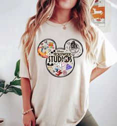 a woman wearing a white tshirt with mickey mouse on it