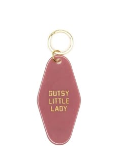 a red keychain with the words gutsy little lady printed on it's side