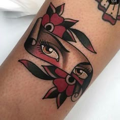 a close up of a person's leg with tattoos on it and an eye