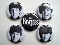 the beatles button badges are arranged on a white surface