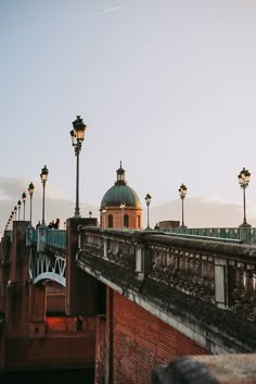 an old bridge with some lights on it