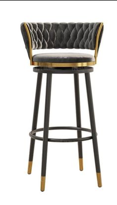 an upholstered bar stool with black velvet and gold trimmings on the back