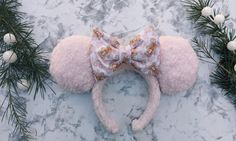 "Light pink sherpa ears with the sweetest little gingerbread mice bow. The cutest Christmastime vibes! Perfect for winter trip to the castle!  May vary slightly from photo as each pair is handmade. My ears and bow are handmade and sewn on to a thicker 1 inch headband. They are lightweight and comfortable. Each ear has a small amount of fluff added inside for sturdiness and a realistic mouse ear appearance. If you'd like another bow than the color shown, please message me for custom requests! Any questions, please send me a message before ordering! This style fits perfectly for kids - adults and comfortable to wear in the parks your entire trip! You will get compliments all day with this red, green and white pair of mouse ears to go perfectly for your trip to the castle! ALL SALES ARE FINAL Christmas Disney Outfits, Mouse Headband, Pink Sherpa, Winter Trip, Christmas Disney, Disney Outfit, Disney Ears, Turban Headbands, Christmas Gingerbread