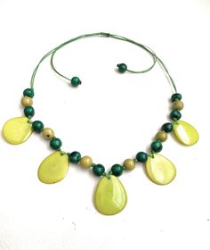 Taua Nut Necklace Necklace Length: 32 inches adjustable to shorter length Adjustable Yellow Necklaces With Wooden Beads, Adjustable Yellow Necklace With Wooden Beads, Adjustable Yellow Wooden Beads Necklace, Adjustable Green Beaded Necklace, Adjustable Round Beads Shell Necklace, Green Beaded Necklace With Adjustable Chain, Green Necklace With Adjustable Length For Gift, Adjustable Green Beaded Shell Necklace, Adjustable 16-inch Beaded Necklaces