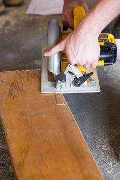 a person using a power tool on a piece of wood