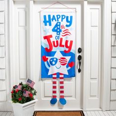 a patriotic fourth of july banner hangs on the front door to welcome you for the fourth of july