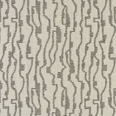 an upholstered fabric with wavy lines in grey and black on a white background