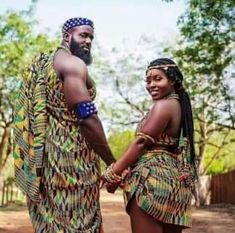 a man and woman dressed in african clothing