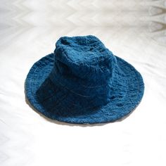 A reversible bucket hat inspired by the wide-brimmed floppiness of fantastical wizard hats, alluding to a connection to another invisible world that may grant protection and safe passage on a voyage. The + symbol, or tapak dara, often painted at the front gates of homes in Bali, is believed to ward off troublesome spirits. 100% handwoven organic cotton 100% hand painted batik 100% botanical dyes GOTS certified organic cotton sewing thread Cut and sewn with care in Bali Limited stock available fo Wizard Hats, Reversible Bucket Hat, Botanical Dyeing, Front Gates, Hats For Sale, Sewing Thread, Limited Stock, Wide Brimmed, Leaf Tattoos