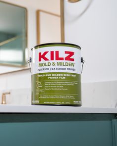 a can of kilz mold and mildew sits on top of a bathroom counter