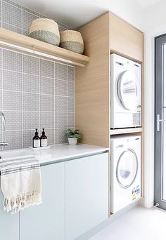 a washer and dryer in a small room next to a window with glass doors