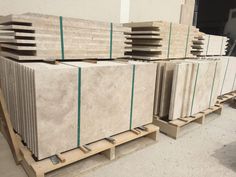 marble slabs are stacked on pallets in a warehouse