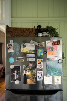 a refrigerator covered in magnets and pictures