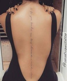 the back of a woman's neck with words written in cursive writing